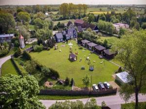 an aerial view of a house with a large yard at Comfortable holiday homes, jacuzzi, summer pool in Łacko