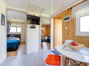 a kitchen and living room with a table and chairs at Comfortable holiday homes, jacuzzi, summer pool in Łacko +21 photos