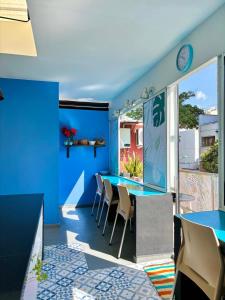 a dining room with blue walls and a table and chairs at Hotel Anauco in Bucaramanga