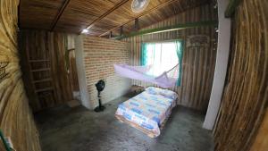an overhead view of a bedroom with a bed and a hammock at Casa Grulla in Santa Marta