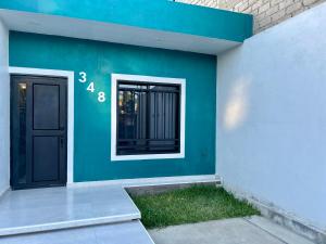 a house with a blue wall and a door at Departamento la estación Tequila in Tequila