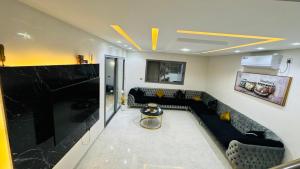 a living room with a couch and a fireplace at Villa DEJRBA De LUXE in Houmt Souk