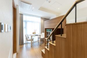 a living room with a staircase and a table at akastay Myeongdong in Seoul