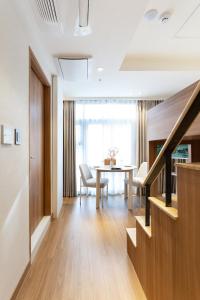 a living room with a table and a dining room at akastay Myeongdong in Seoul