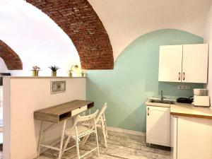 a kitchen with a table and chairs in a room at Roxen Central Studio Sibiu in Sibiu