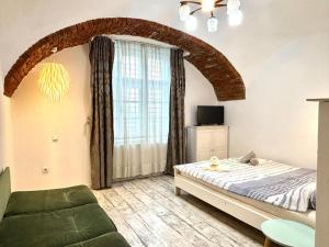 a bedroom with a bed and a large window at Roxen Central Studio Sibiu in Sibiu
