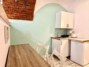 a small kitchen with a table and two chairs at Roxen Central Studio Sibiu in Sibiu