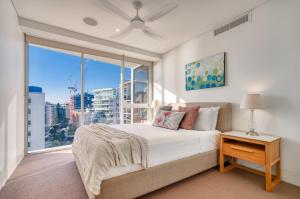 a bedroom with a bed and a large window at Sea Pearl A1 Beach Resort in Mooloolaba +284 photos