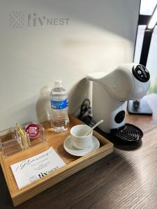 a wooden tray with a coffee maker and a cup of coffee at Private Suite with bathroom and top amenities in La Cañada