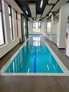 a large swimming pool with blue water in a building at Private Suite with bathroom and top amenities in La Cañada +24 photos
