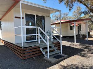 a home with a staircase leading to the front door at Major Mitchell Caravan Park in Mitchell