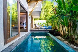 a swimming pool in the backyard of a house at Jellyfish Villas Bingin, Uluwatu in Uluwatu