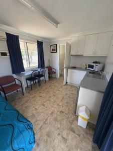 a kitchen and living room with a table and chairs at Major Mitchell Caravan Park in Mitchell +7 photos