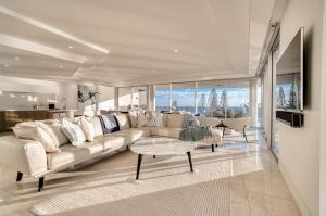 a living room with a large couch and a table at Sea Pearl A1 Beach Resort in Mooloolaba