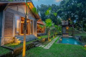 a house with a swimming pool in front of it at Balian Hideaway - MON Villa in Balian