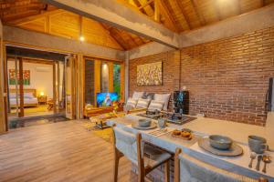 a living room with a brick wall at Balian Hideaway - MON Villa in Balian