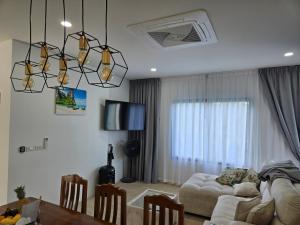 a living room with a couch and a table at Vanesa Serenity Villa 1 in Ban Chong Phli