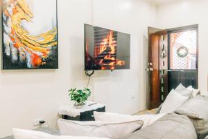a living room with a couch and a tv on the wall at Casa de Oro in Iyam