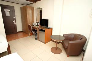 a room with a desk and a chair and a computer at O Hotel in Bacolod