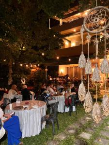 a group of people sitting at tables at a restaurant at AT ONE - with Nature Glamping, Rekawa in Tangalle +113 photos