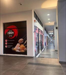 a hallway of a store with a sign on the wall at JC COZYsTAY RAWANG in Rawang