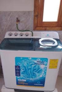 a maytag performance washer sitting on top of a refrigerator at Fifi Shouse Ayangue in Santa Elena