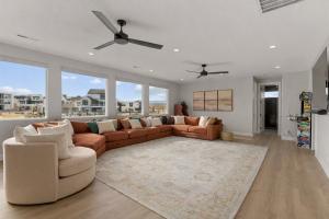 a living room with a couch and chairs and windows at Terra Rossa townhouse in St. George