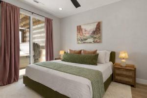 a bedroom with a large bed and a window at Terra Rossa townhouse in St. George