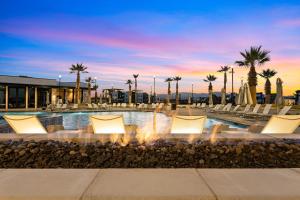 a swimming pool with chairs and a fountain at Terra Rossa townhouse in St. George