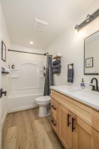 a bathroom with a tub and a toilet and a sink at The Flats- Executive Suite-Downtown CDA in Coeur d'Alene