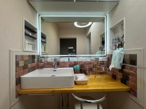 a bathroom with a sink and a mirror at Lhouseー遊べる宿ビリヤード 大型スクリーン 岡山駅徒歩15分 in Okayama +35 photos