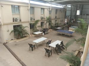 a courtyard with tables and chairs in a building at Accommodation @ Isa in Mount Isa