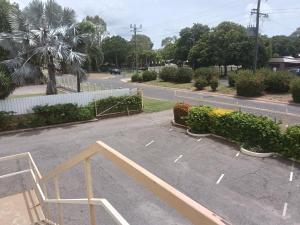 a parking lot with a bench on the side of a road at Accommodation @ Isa in Mount Isa +9 photos