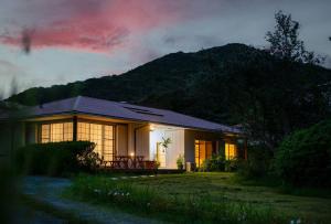 a house with a table in front of it at night at villa itsutsu in Kamigotō