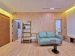 a living room with a blue couch and a ladder at Little House Sea in Nha Trang +8 photos