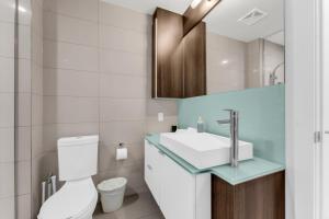 a bathroom with a toilet and a sink at Eleve Toronto Residences in Toronto +24 photos