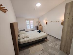 a bedroom with a bed and a window at Auberge du Bourguet in Brenon