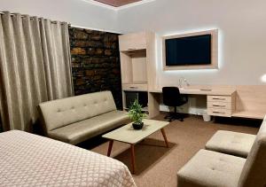 a hotel room with a bed and a desk with a computer at Hotel La Villa Mollendo in Mollendo
