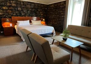 a bedroom with a bed and a couch and a table at Hotel La Villa Mollendo in Mollendo +27 photos
