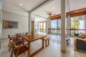 a dining room and living room with a table and chairs at Cove Ruma Coliving in Denpasar