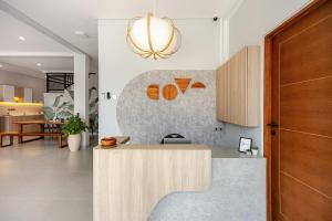a kitchen with a wooden counter top in a room at Cove Ruma Coliving in Denpasar +24 photos