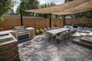 a patio with a table and chairs and a grill at Assemble Boise in Boise