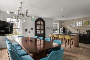 a kitchen and dining room with a wooden table and blue chairs at Assemble Boise in Boise