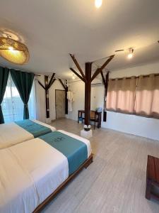 a bedroom with a bed with a tree in it at Villa Bari Loft in Setiu