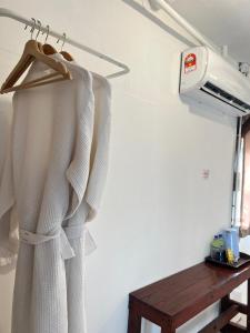 a robe hanging on a rack in a room at Villa Bari Loft in Setiu