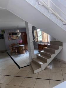 a staircase in a living room with a table at Hotel Classic in Porangatu