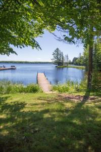 a dock in the middle of a lake at Cedar Cove Cabin 5 in Butternut