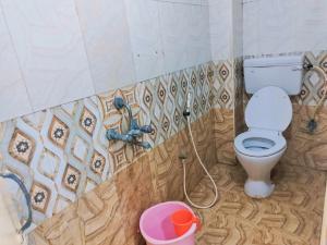 a bathroom with a toilet and a water hose at Hotel Mtc Guest House in Chennai