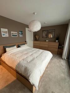 a bedroom with a large bed and a large orb at Bausje Beach House in Farsund