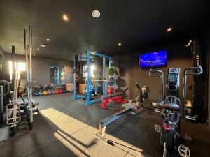a fitness room with a gym with machines at Bausje Beach House in Farsund